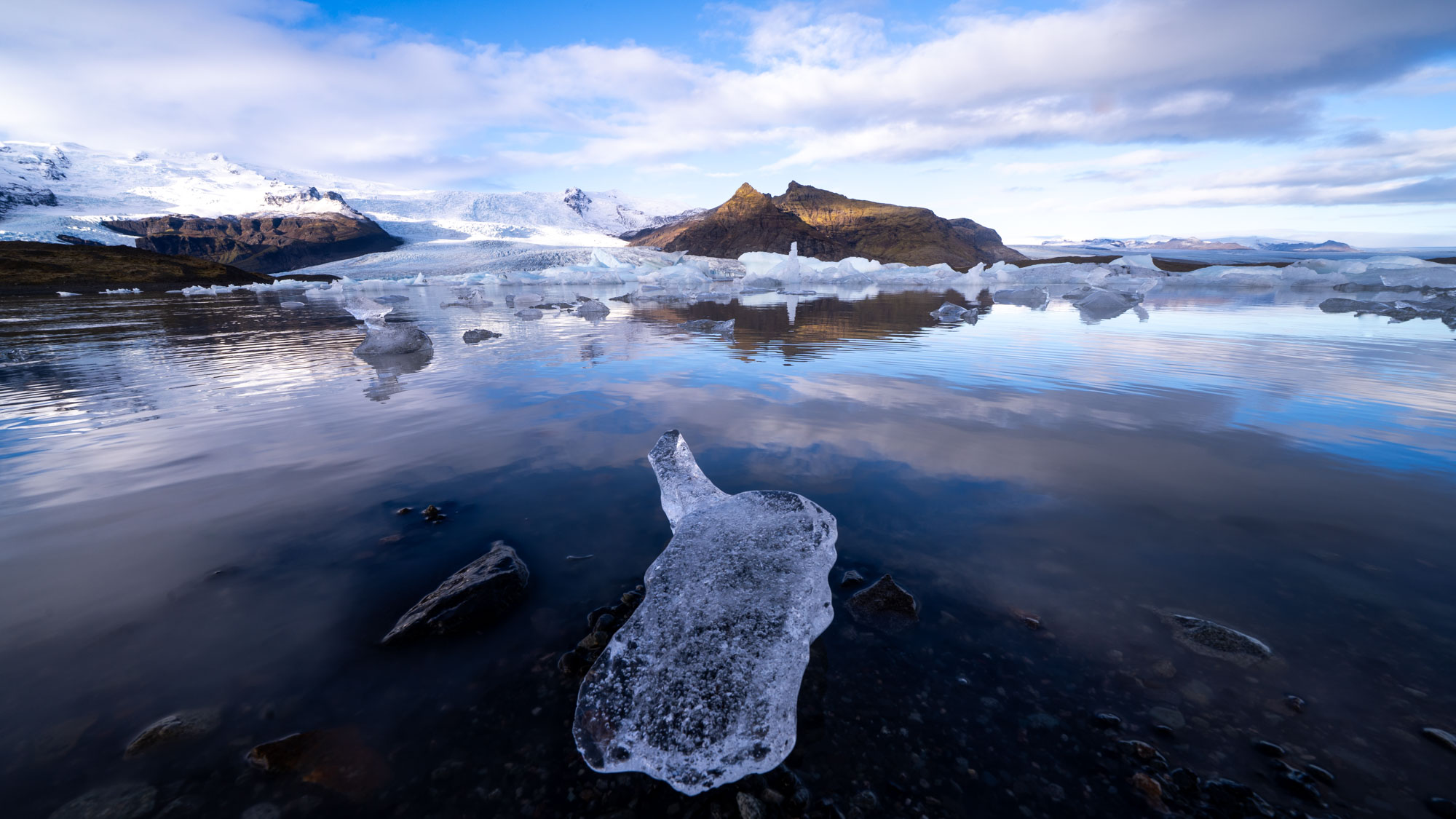 Ice and mountains reflected in an Icelandic glacier lagoon, retouched by Serge Ramelli